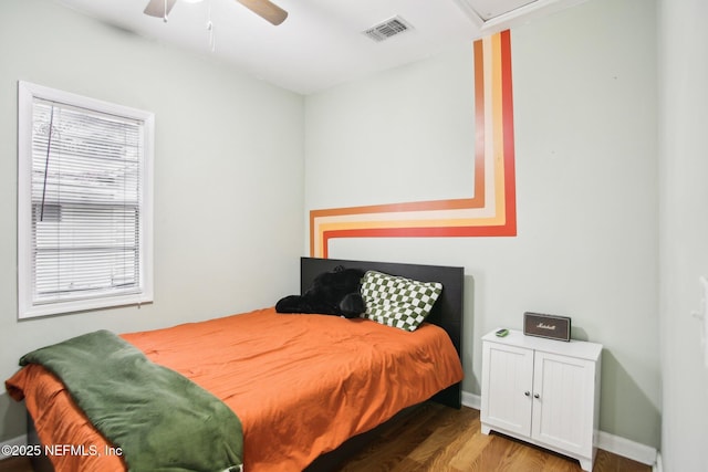 bedroom with ceiling fan and hardwood / wood-style flooring