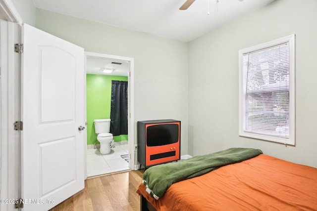 bedroom featuring ensuite bathroom, ceiling fan, and light hardwood / wood-style floors