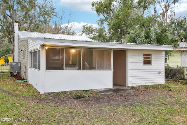 back of property featuring a sunroom