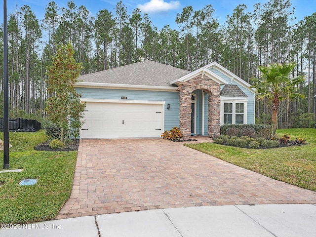 view of front of property featuring a front yard and a garage