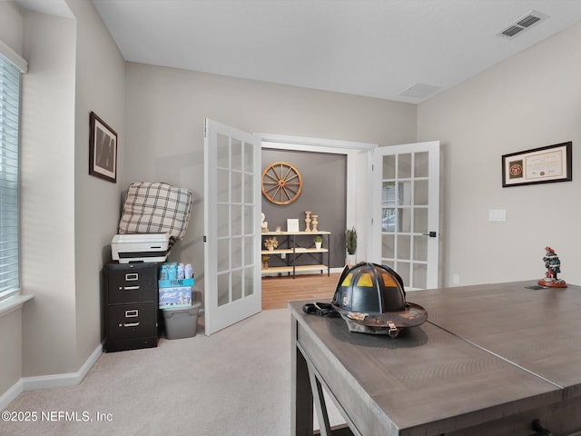 office space with light colored carpet and french doors