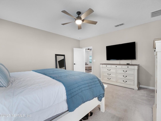 bedroom with ceiling fan and light colored carpet