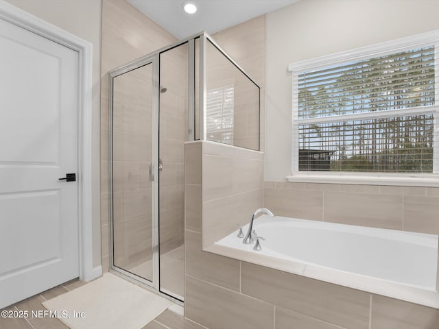 bathroom with independent shower and bath and tile patterned flooring