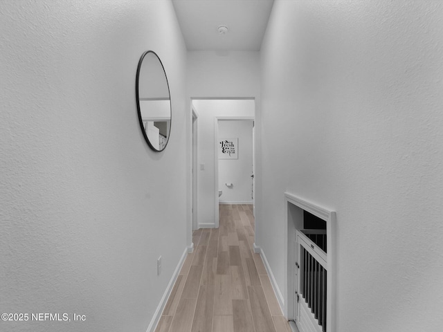 hallway with light hardwood / wood-style floors