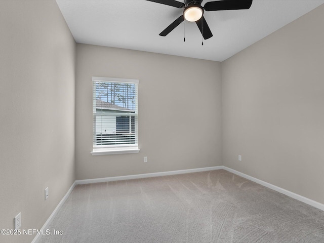 carpeted empty room featuring ceiling fan