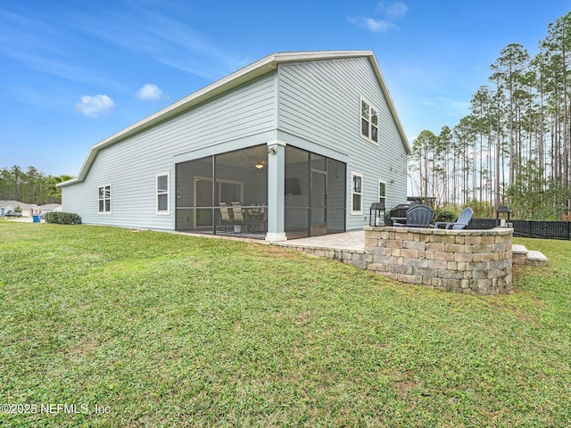 back of property featuring a patio area, a sunroom, and a lawn