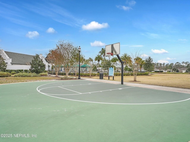 view of sport court with a lawn