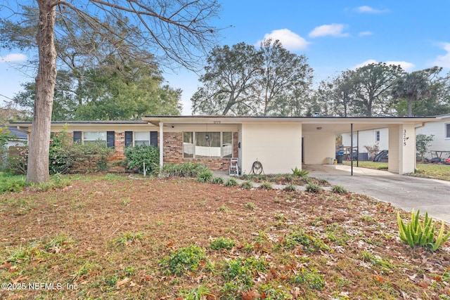 ranch-style house featuring a carport