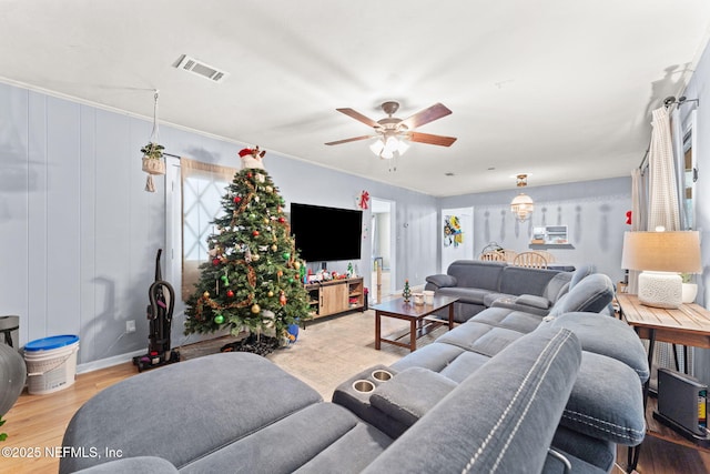 living room featuring ceiling fan, light hardwood / wood-style flooring, and ornamental molding