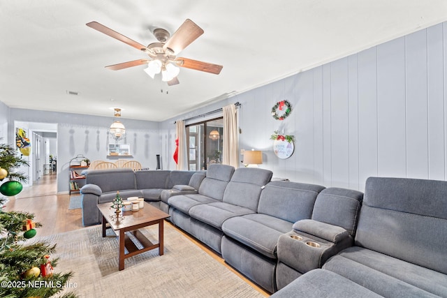 living room featuring light hardwood / wood-style floors and ceiling fan