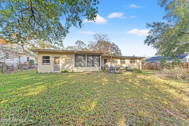 rear view of house featuring a lawn