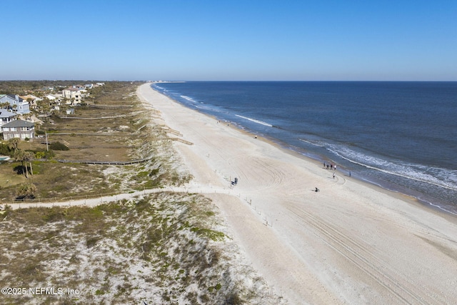 drone / aerial view featuring a view of the beach and a water view