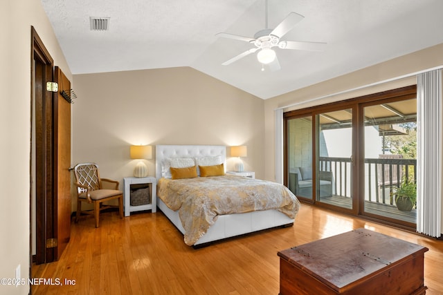 bedroom featuring access to exterior, visible vents, vaulted ceiling, ceiling fan, and light wood-type flooring