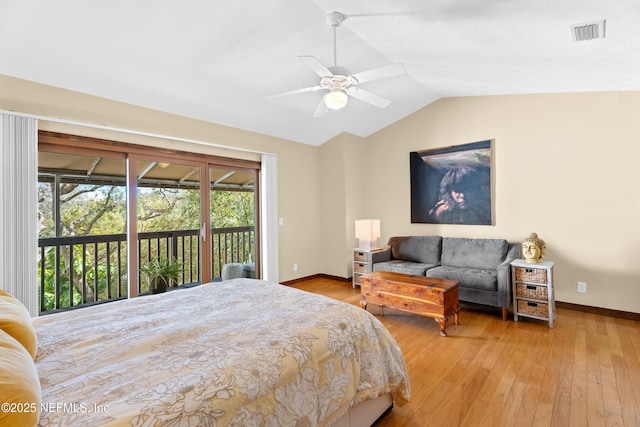 bedroom featuring access to exterior, lofted ceiling, visible vents, hardwood / wood-style floors, and baseboards