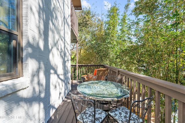 wooden terrace featuring outdoor dining area