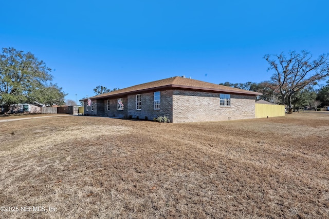 view of property exterior with a yard