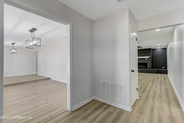 hallway with light hardwood / wood-style flooring