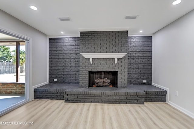 unfurnished living room featuring a fireplace and wood-type flooring