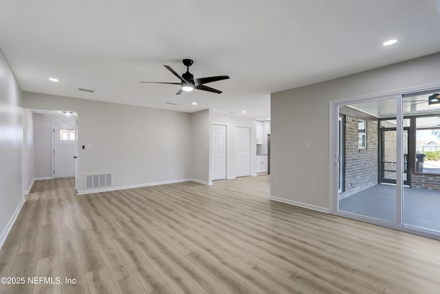 unfurnished living room with a wealth of natural light, ceiling fan, and light hardwood / wood-style flooring