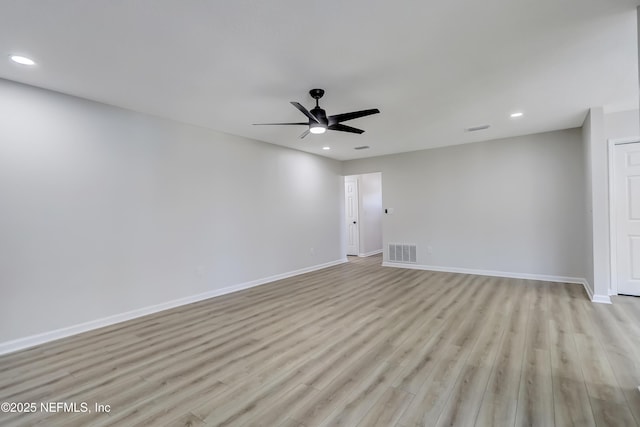 empty room featuring ceiling fan and light hardwood / wood-style floors