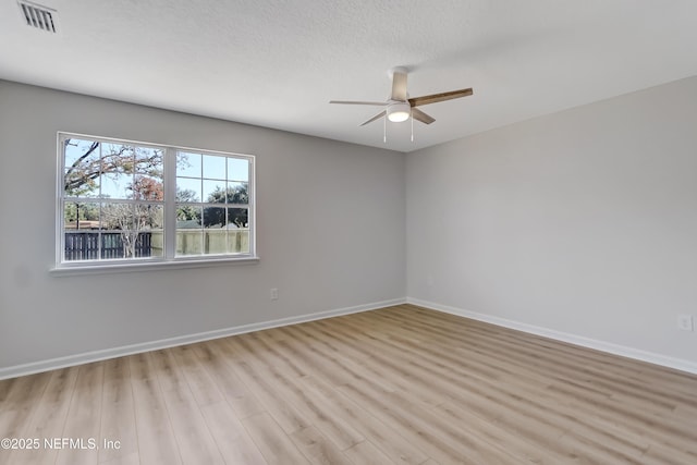 spare room featuring light hardwood / wood-style floors and ceiling fan