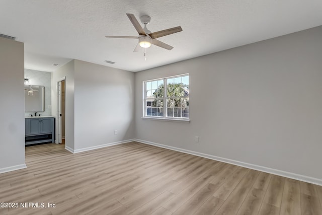 empty room featuring ceiling fan and light hardwood / wood-style flooring