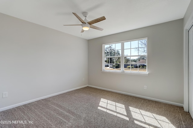 empty room with ceiling fan and carpet flooring