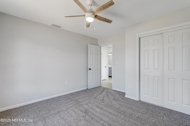 unfurnished bedroom featuring light carpet, ceiling fan, and a closet