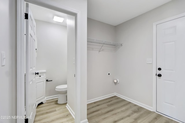 clothes washing area with light wood-type flooring and electric dryer hookup