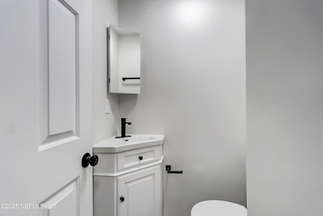 bathroom featuring vanity and toilet