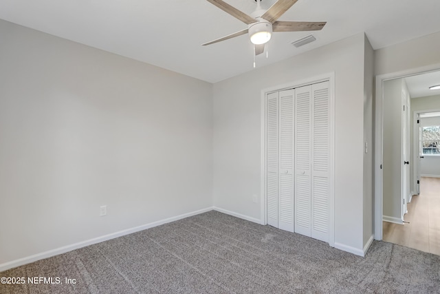 unfurnished bedroom with ceiling fan, carpet floors, and a closet