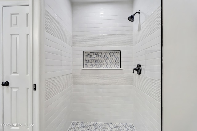 bathroom with tiled shower