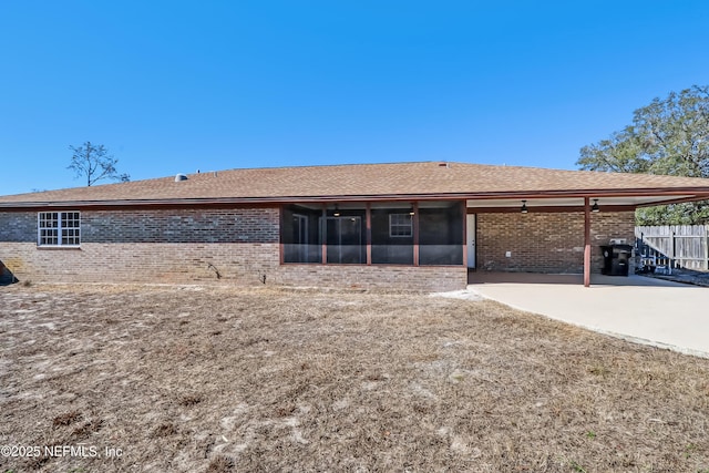 view of front of house with a sunroom and a patio area