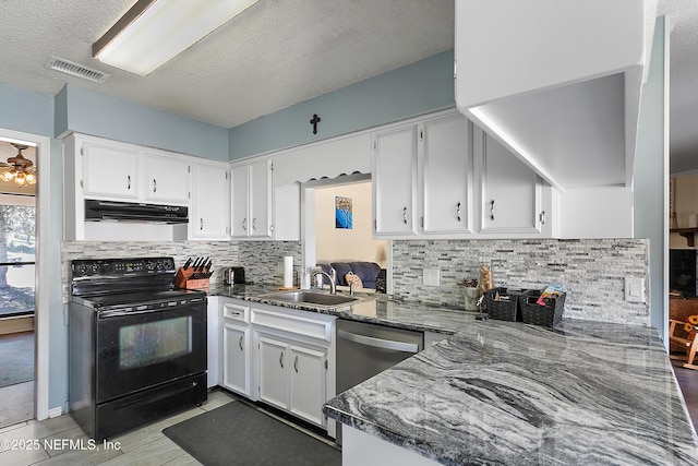 kitchen with sink, electric range, dark stone countertops, white cabinetry, and light tile patterned flooring