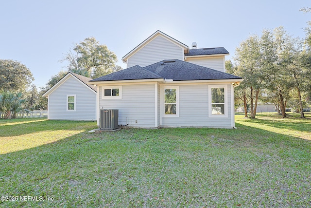 back of house featuring a yard and central AC