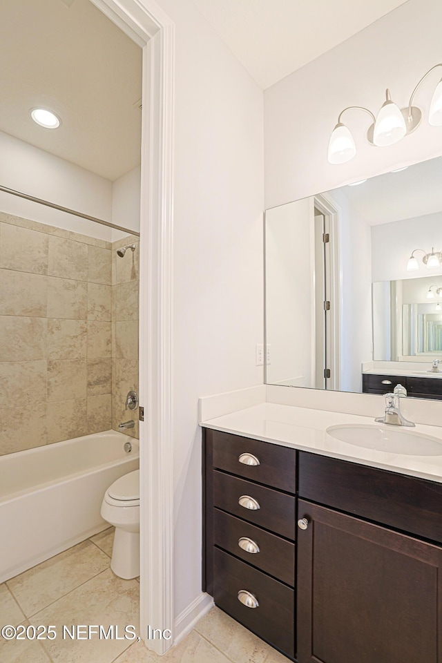 full bathroom with toilet, vanity, tile patterned flooring, and tiled shower / bath combo