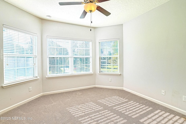 carpeted empty room featuring a textured ceiling and ceiling fan