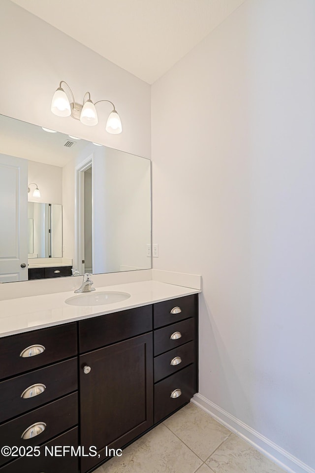 bathroom with tile patterned floors and vanity