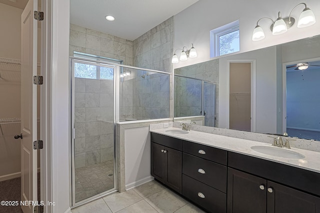 bathroom with tile patterned floors, a shower with shower door, and a healthy amount of sunlight