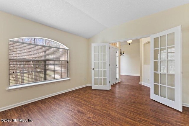 unfurnished room with dark hardwood / wood-style floors, french doors, and vaulted ceiling