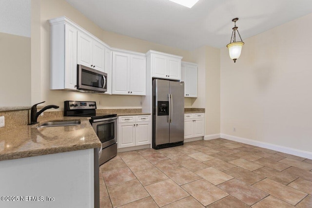 kitchen featuring appliances with stainless steel finishes, sink, decorative light fixtures, white cabinets, and stone countertops