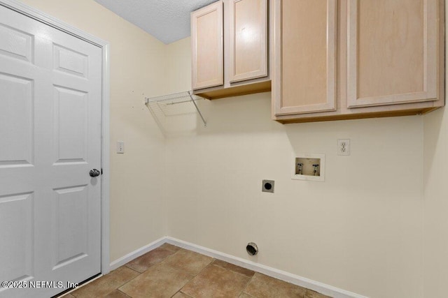 laundry room featuring cabinets, washer hookup, a textured ceiling, and hookup for an electric dryer