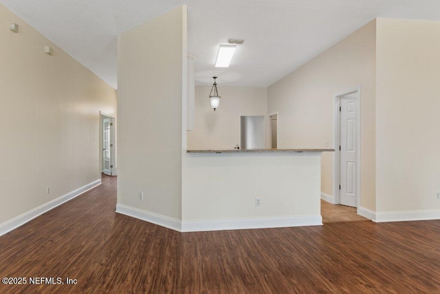 unfurnished living room with dark wood-type flooring