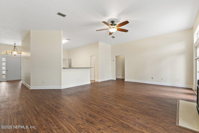 unfurnished living room with ceiling fan, a healthy amount of sunlight, and dark hardwood / wood-style flooring