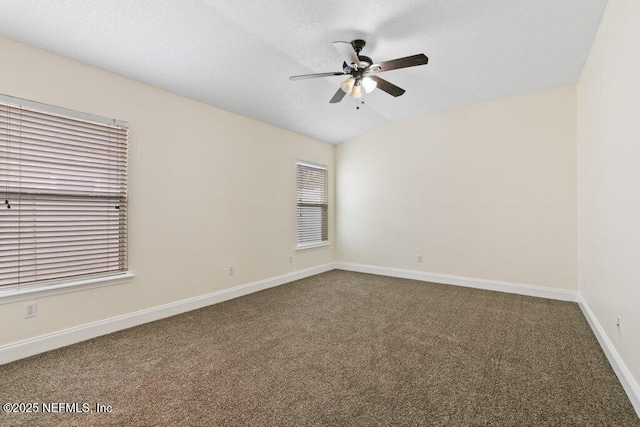 carpeted spare room featuring ceiling fan and lofted ceiling