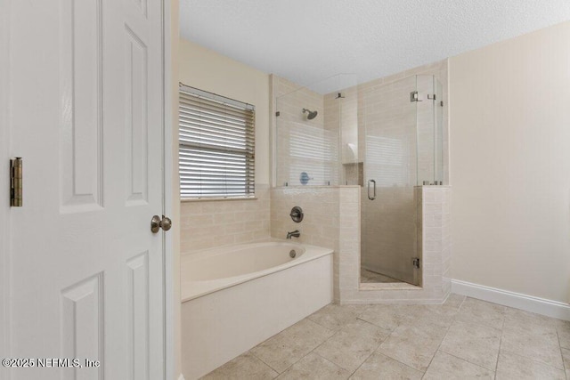 bathroom featuring independent shower and bath, a textured ceiling, and tile patterned floors