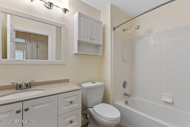 full bathroom with a textured ceiling, toilet, vanity, and bathing tub / shower combination