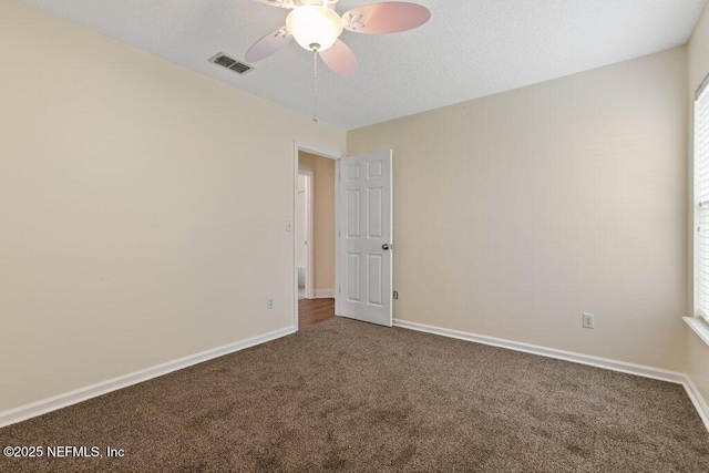 spare room featuring carpet floors and ceiling fan