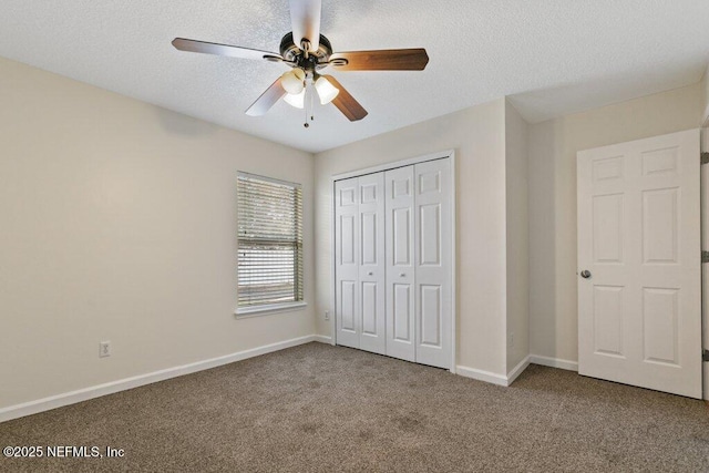 unfurnished bedroom with ceiling fan, carpet, a closet, and a textured ceiling