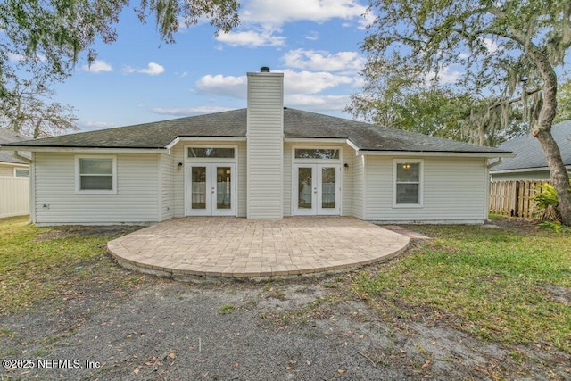 back of house with a patio, french doors, and a lawn